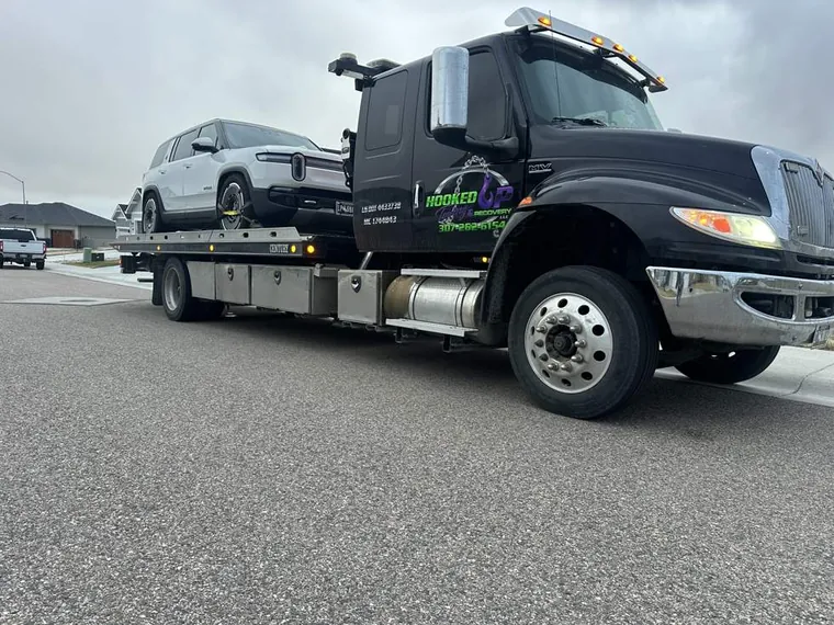 Rivian electric SUV secured on flatbed tow truck in Casper WY