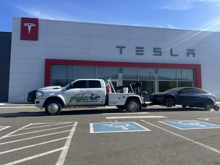 Tesla delivered to service center by Hooked Up Towing wheel-lift tow truck